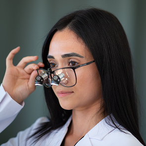 Clinician wearing ergonomic loupes