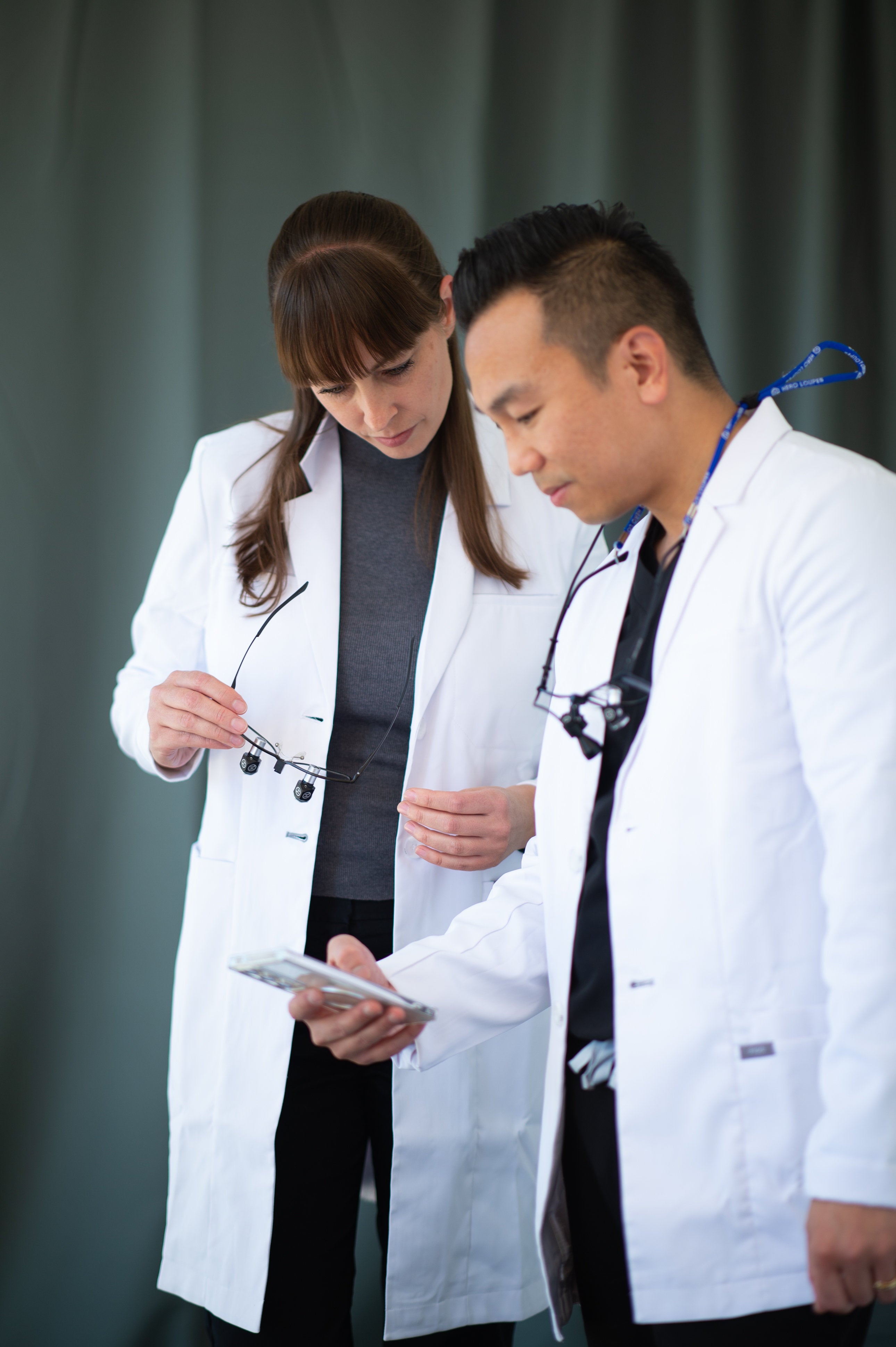Clinicians reviewing support on a phone